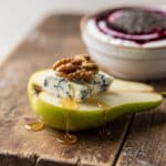 Healthy snack board with fresh vegetables hummus nuts and energy balls