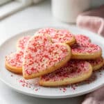Pink and white heart shaped sugar cookies with glossy royal icing