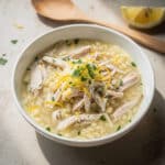 Creamy lemon chicken orzo soup recipe in a rustic white bowl