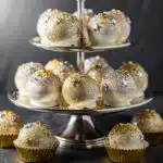 Festive New Years Eve cake ball drops with gold and silver sprinkles.