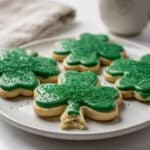 Shamrock sugar cookies with creamy green icing for St Patrick's Day.