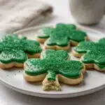 Shamrock sugar cookies with creamy green icing for St Patrick's Day.