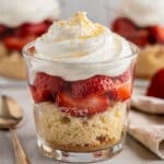 Strawberry shortcake cups with juicy berries and creamy whipped cream layers.