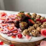 Valentine's Day treat platter with chocolate strawberries and pink yogurt bark.