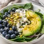 Fresh spring salad with blueberries pistachios feta and lemon poppy seed dressing