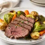 Oven braised corned beef and cabbage in a rustic cast iron dutch oven.