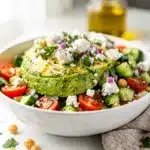 Creamy chickpea feta avocado salad recipe in a rustic white bowl