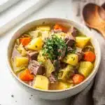 Hearty corned beef and cabbage soup with potatoes in creamy broth
