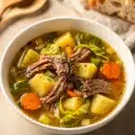Hearty corned beef cabbage soup with tender potatoes in creamy broth.