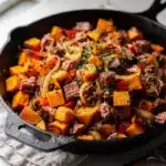 Crispy corned beef hash with sweet potatoes in a homemade brunch recipe.