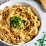 Creamy homemade French onion dip with caramelized onions and fresh chives.