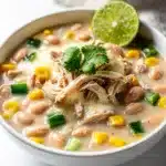 Creamy white chicken chili with cilantro and jalapeños in a rustic bowl.
