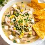 Creamy white chicken chili with shredded chicken beans and corn close up