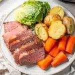 Instant Pot corned beef and cabbage plated with potatoes carrots and parsley