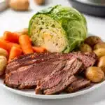 Instant Pot corned beef and cabbage family meal on a white platter