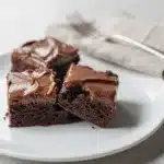 Irish cream brownies with glossy ganache in close up Pinterest style photo