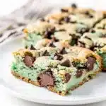 Mint chocolate chip cookie bars are chewy green treats with dark chocolate chips.