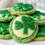 Shamrock sugar cookies with creamy icing for a festive St Patrick's Day treat.