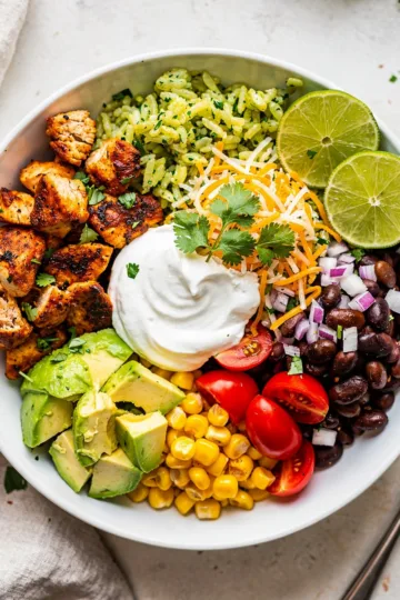 Spicy chicken burrito bowl recipe with avocado and crispy tortilla strips