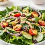 Fresh spring mix salad with creamy honey mustard dressing and colorful toppings.