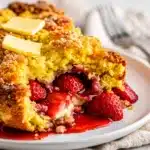 Rustic strawberry dump cake with golden crumble topping and vanilla ice cream.