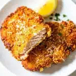Crispy air fryer chicken cutlets with golden panko breading and lemon garnish.
