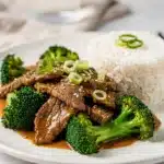 Cozy beef and broccoli stir fry with glossy sauce in a white bowl