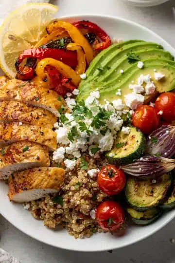 Colorful chicken and quinoa bowl with avocado and roasted vegetables recipe