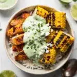 Chicken street corn rice bowl with spiced chicken and zesty lime crema