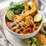 Creamy avocado and crispy tortilla strips top this chicken tortilla soup recipe.