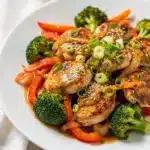 Colorful chicken and veggie stir fry with glossy sauce in close up Pinterest style
