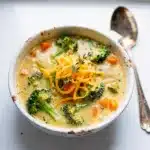 Creamy broccoli cheddar soup recipe in a close up Pinterest style photo