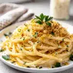Creamy garlic parmesan pasta with crispy breadcrumbs and fresh parsley garnish.
