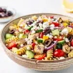 Greek chicken pasta salad with cucumber olives feta in Mediterranean style plating