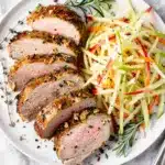 Close up of juicy herb roasted pork tenderloin with crispy golden crust