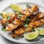 Honey lime chicken skewers with a glossy glaze and fresh cilantro garnish.