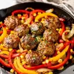 One pan sausage and peppers with sweet corn in a rustic skillet