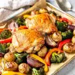 Sheet pan chicken and veggies with roasted potatoes and colorful bell peppers.