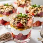 Strawberry yogurt parfait cups with creamy yogurt, juicy strawberries, and crispy granola.
