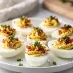 Party Bacon Ranch Deviled Eggs with crispy bacon and fresh chive garnish