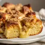 Creamy baked overnight French toast bake with crispy golden edges and berries.