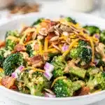Crisp broccoli bacon salad with cheddar and creamy dressing in bowl