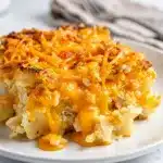 Creamy cheesy hashbrown casserole with crispy potato edges in close up