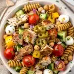 High protein Italian pasta salad with chicken and fresh vegetables in a bowl.
