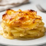 Creamy scalloped potatoes recipe with golden cheese sauce and crispy baked top.