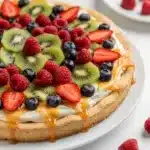 Colorful fruit pizza with sugar cookie crust and cream cheese spread