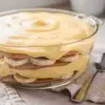 Creamy banana pudding in a glass bowl with soft vanilla wafer layers.