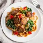 Creamy Cajun sausage pasta with penne, andouille, peppers, spinach, and Parmesan cheese.