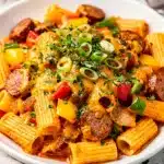 Creamy Cajun sausage pasta with penne in a glossy cheese sauce.
