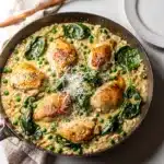 Creamy chicken and rice skillet with parmesan sauce and green vegetables